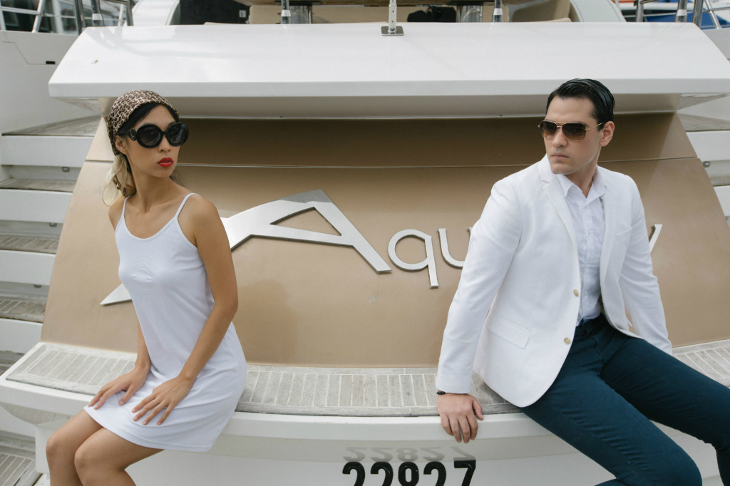 Cissy Zhang and Warren Pasi sitting on a marina in Sydney for a style shoot for their blog