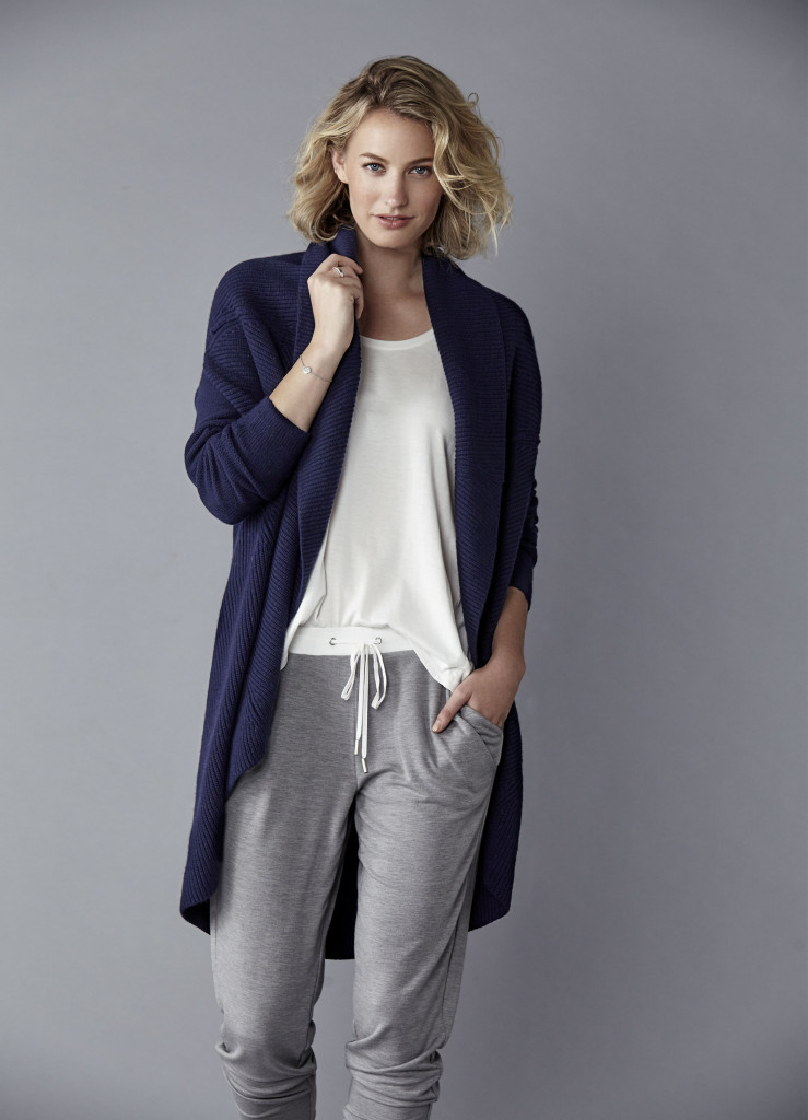 Model in a studio wearing white top, navy cardigan, and grey pant