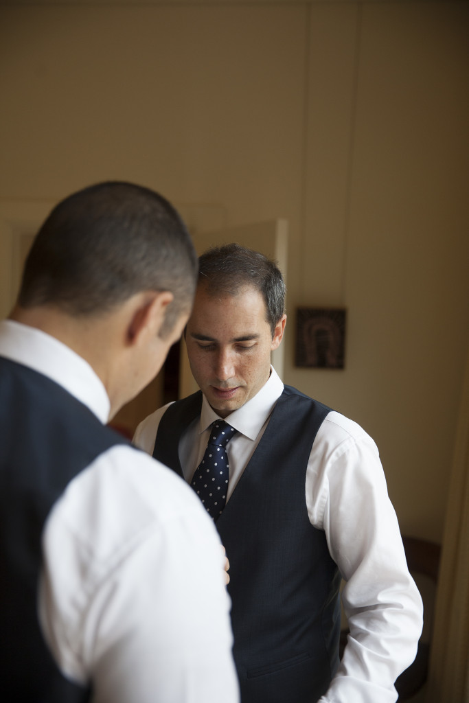 Wedding party dressed in navy blue suits, navy and white spotted tie and white Calvin Klein self patterned shirts.