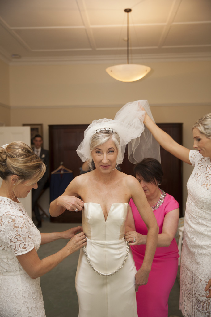 Bride and bridesmaids adding the final touches.