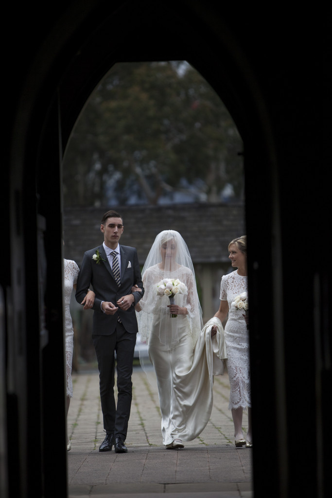 Bridal party walking into the church.