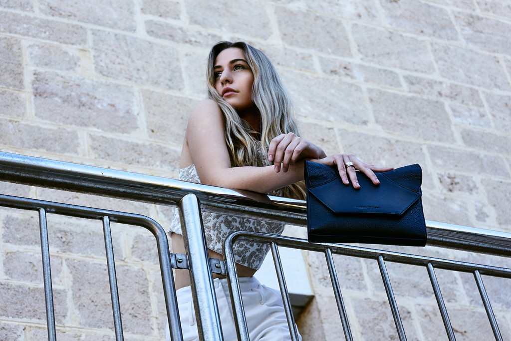 Model standing modelling a Janna Jones Handbag, designer from Perth Western Australia.