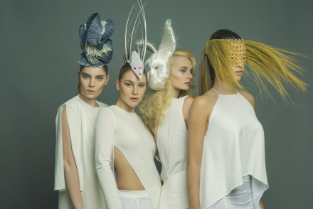 Model standing in a studio wearing the millinery work of Andrew Cannon, a Canberra milliner know as Andrew James Millinery.