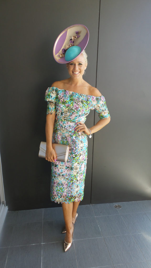 Alice Bright standing in a pastel coloured dress, completely hand made by her, matching hat by Allport Millinery.