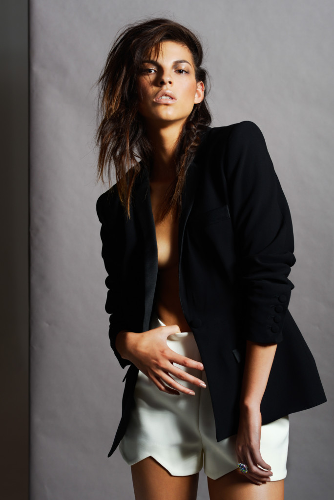 Model with long brown hair in black jacket styled by Elle Giles.